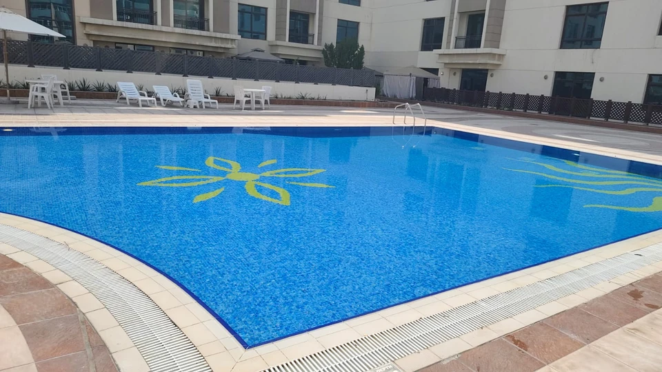 Blue mosaic swimming pool photographed by the client